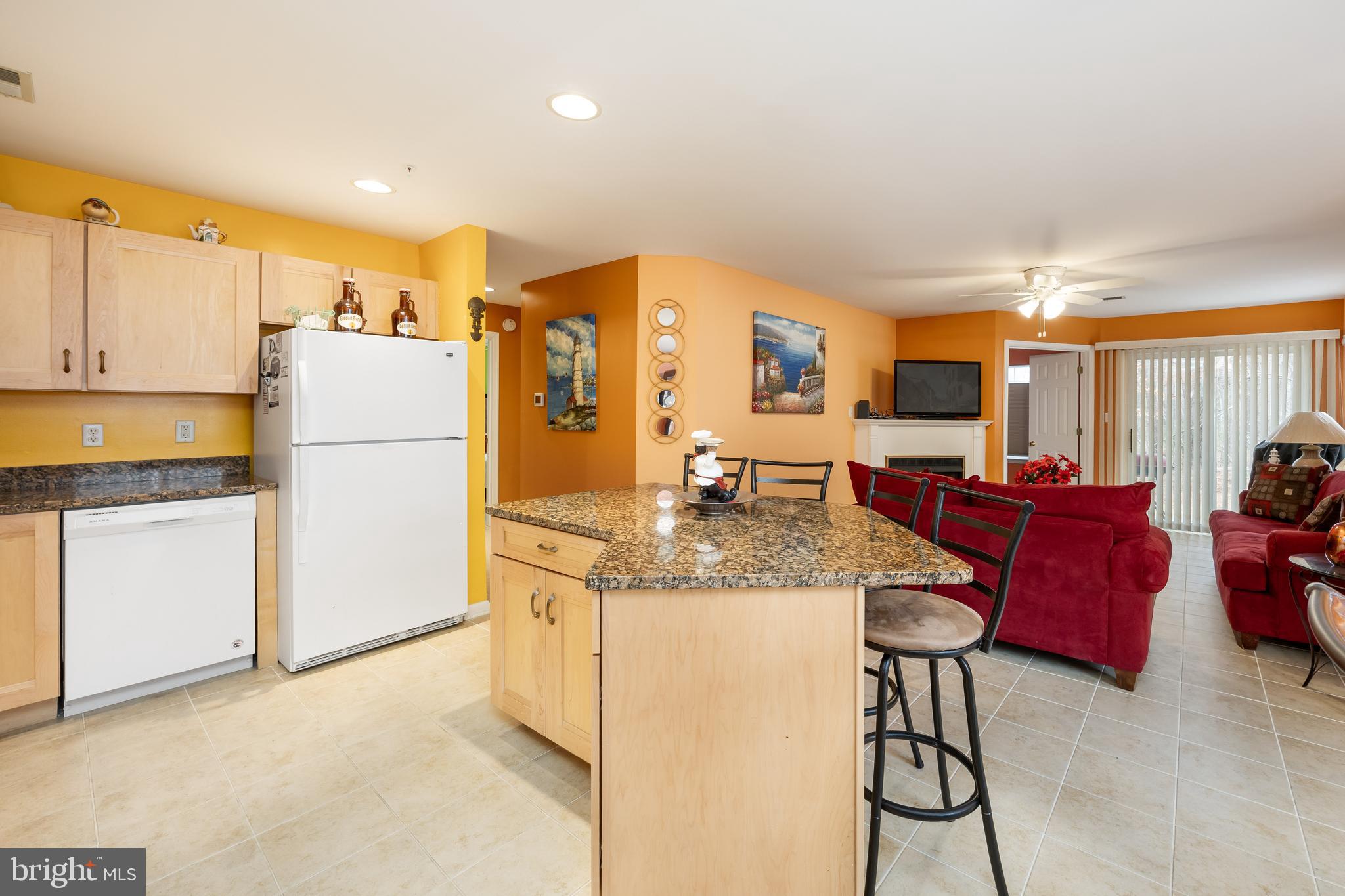 11427 Manklin Creek Road, Unit 7 Ocean Pines, MD 21811 - Photo 8 of 42 a kitchen with stainless steel appliances granite countertop a refrigerator a stove a sink dishwasher and a dining table with the view of kitchen
