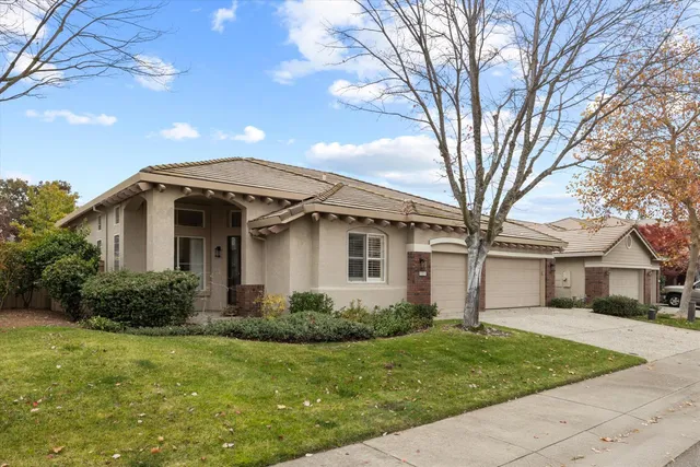 a front view of a house with a garden