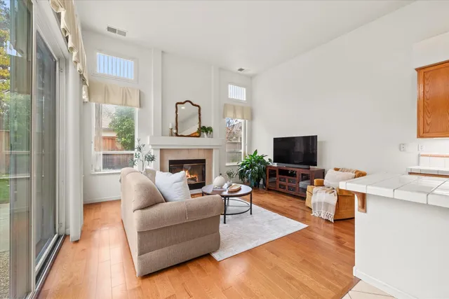 a living room with furniture fireplace and window