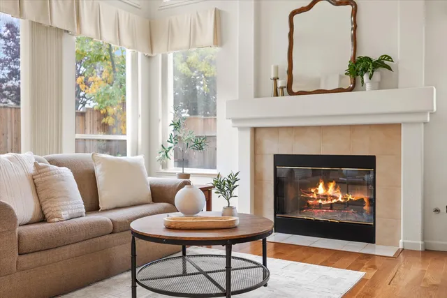 a living room with furniture kitchen view and a flat screen tv
