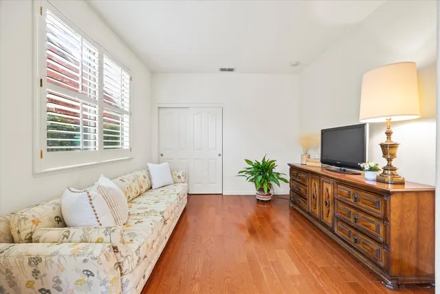 a en suite bathroom with a granite countertop sink and a mirror