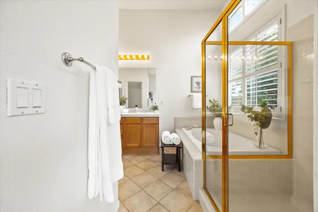 a spacious bathroom with a double vanity sink a mirror and a shower