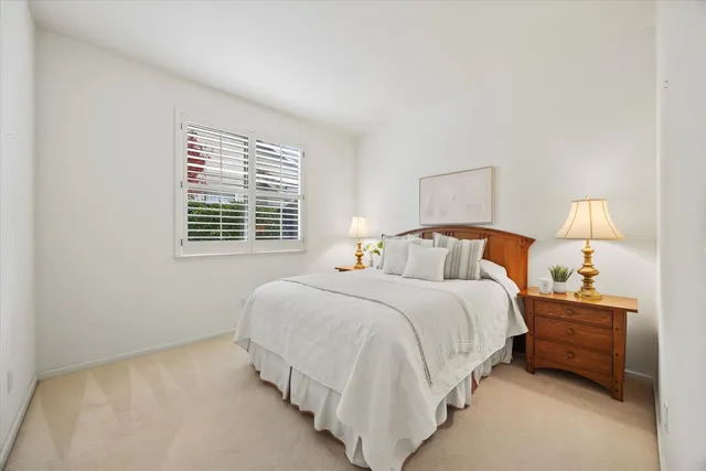 a bedroom with bed and a window