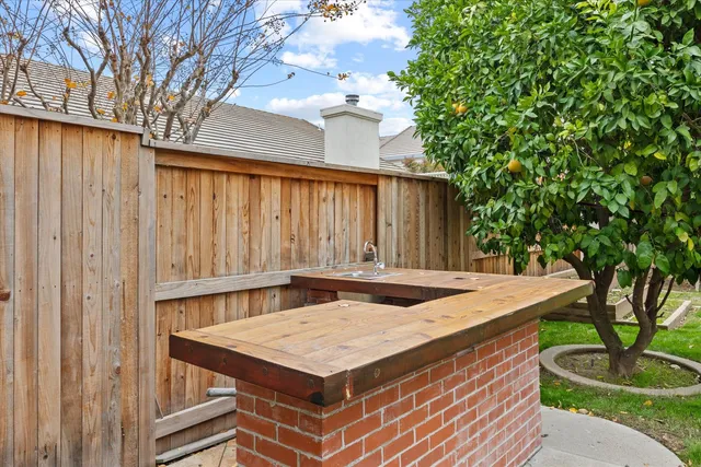 a view of a fountain in the patio with a garden