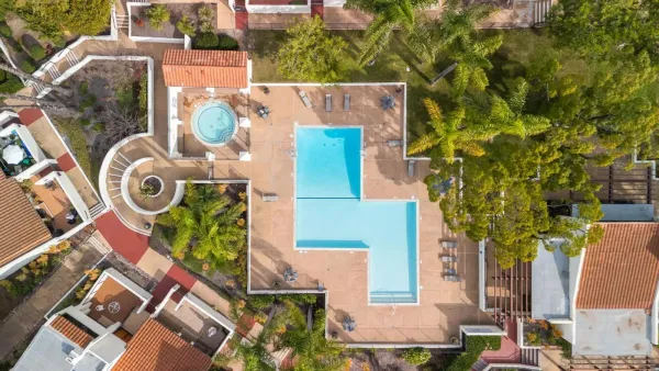 an aerial view of a house with garden space and street view