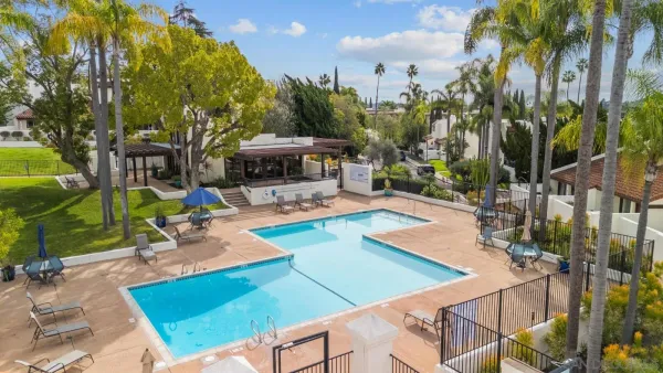 a view of a backyard with swimming pool