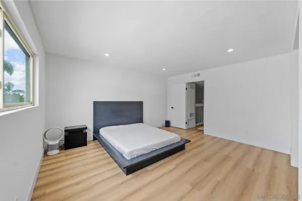 a spacious bedroom with a bed and a table
