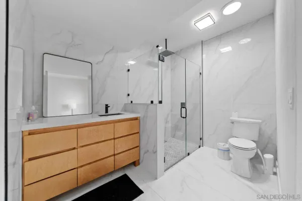 a bathroom with a toilet sink and shower