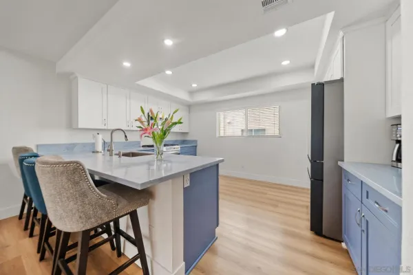 a view of a kitchen area with furniture and wooden floor