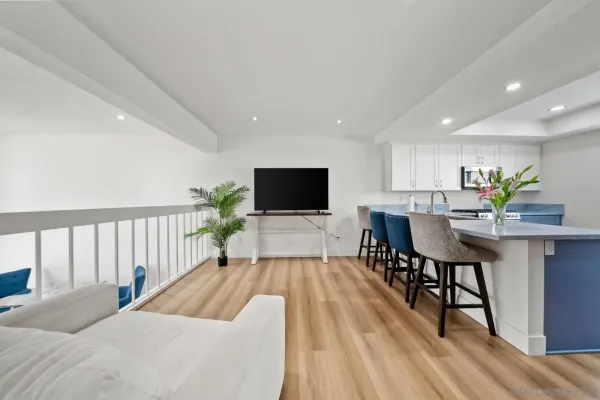 a living room with furniture wooden floor and a flat screen tv