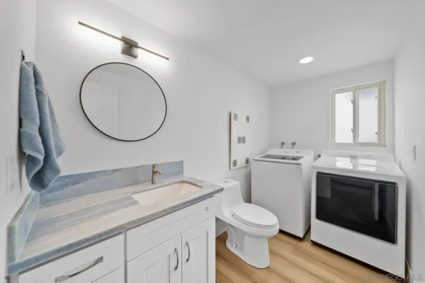 a bathroom with a toilet a sink and a mirror