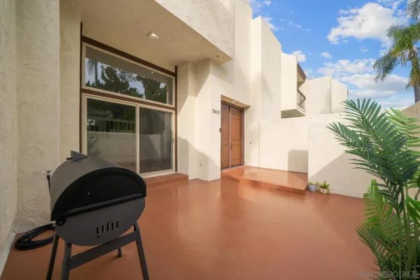a view of a livingroom with furniture and floor to ceiling window