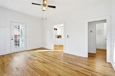 a view of an empty room with wooden floor