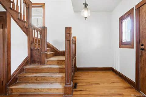 a view of staircase with white walls and railing