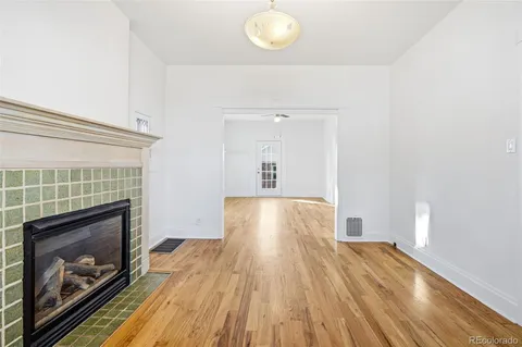 a view of empty room with wooden floor and fireplace