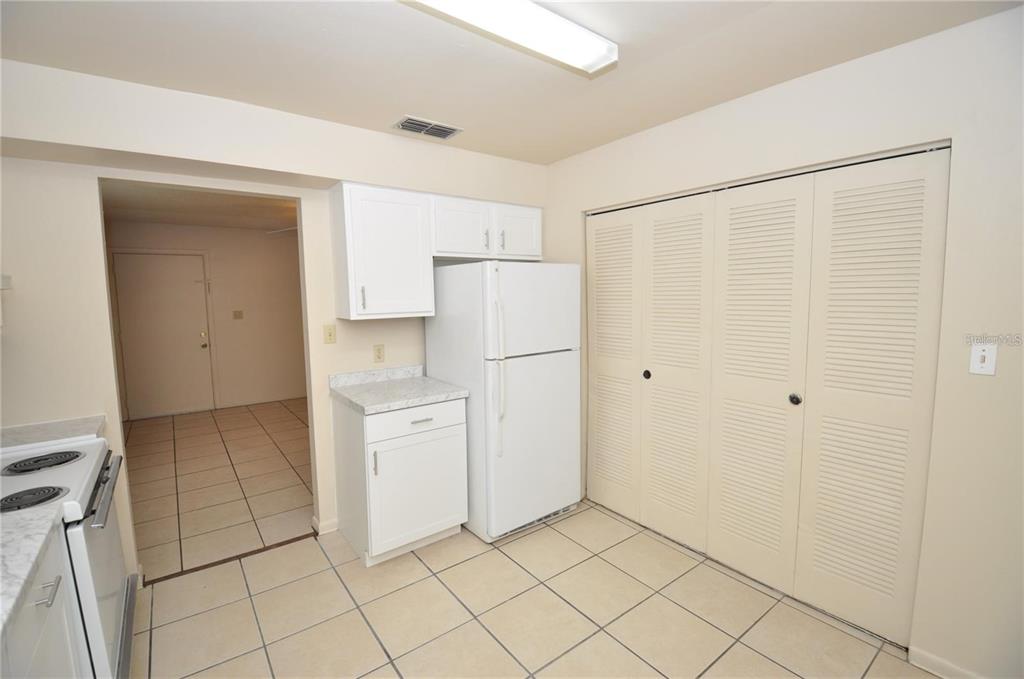 1434 East Fern Road, Unit 1434 Lakeland, FL 33801 - Photo 7 of 13 a kitchen with white cabinets and refrigerator