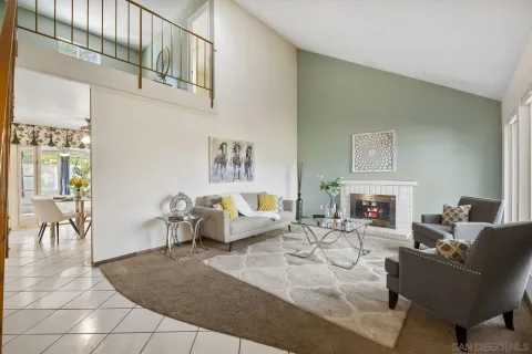 a living room with furniture a fireplace and a table