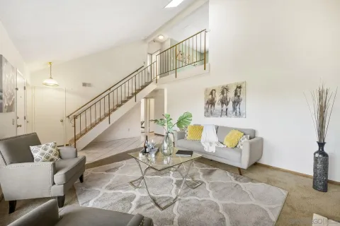 a living room with furniture and stairs