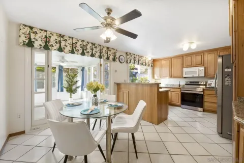 a kitchen with a dining table chairs and cabinets