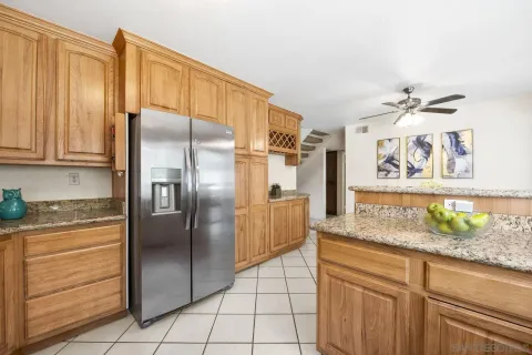 a kitchen with stainless steel appliances granite countertop a refrigerator and a sink