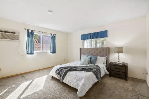 a bedroom with a bed and lamp