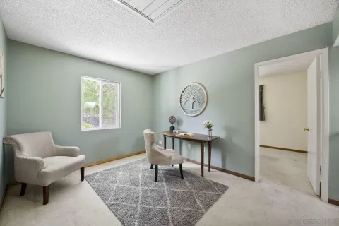 a view of a livingroom with furniture and a window