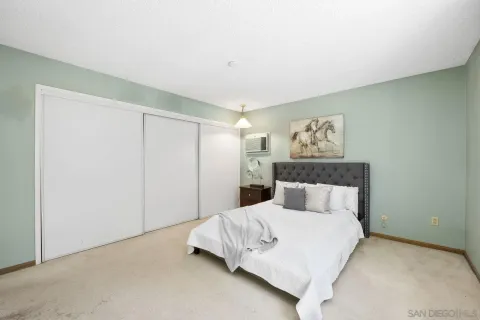 a large bed sitting in a bedroom next to a bathroom