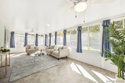 a living room with furniture and large windows