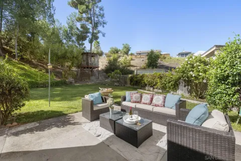 a patio with couch and garden