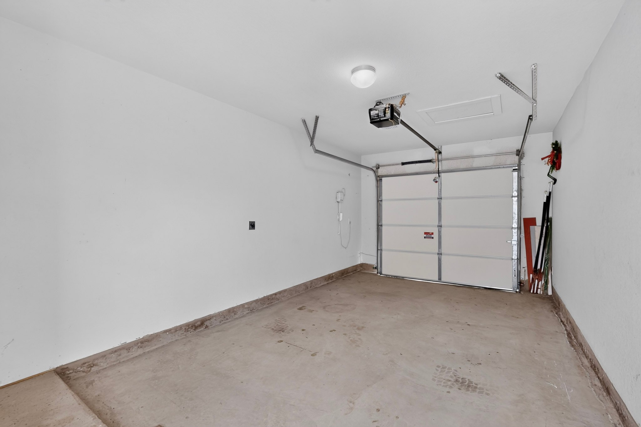 116 Appleberry Lane Elgin, TX 78621 - Photo 30 of 35 A spacious garage featuring a functional garage door opener and ample storage possibilities.