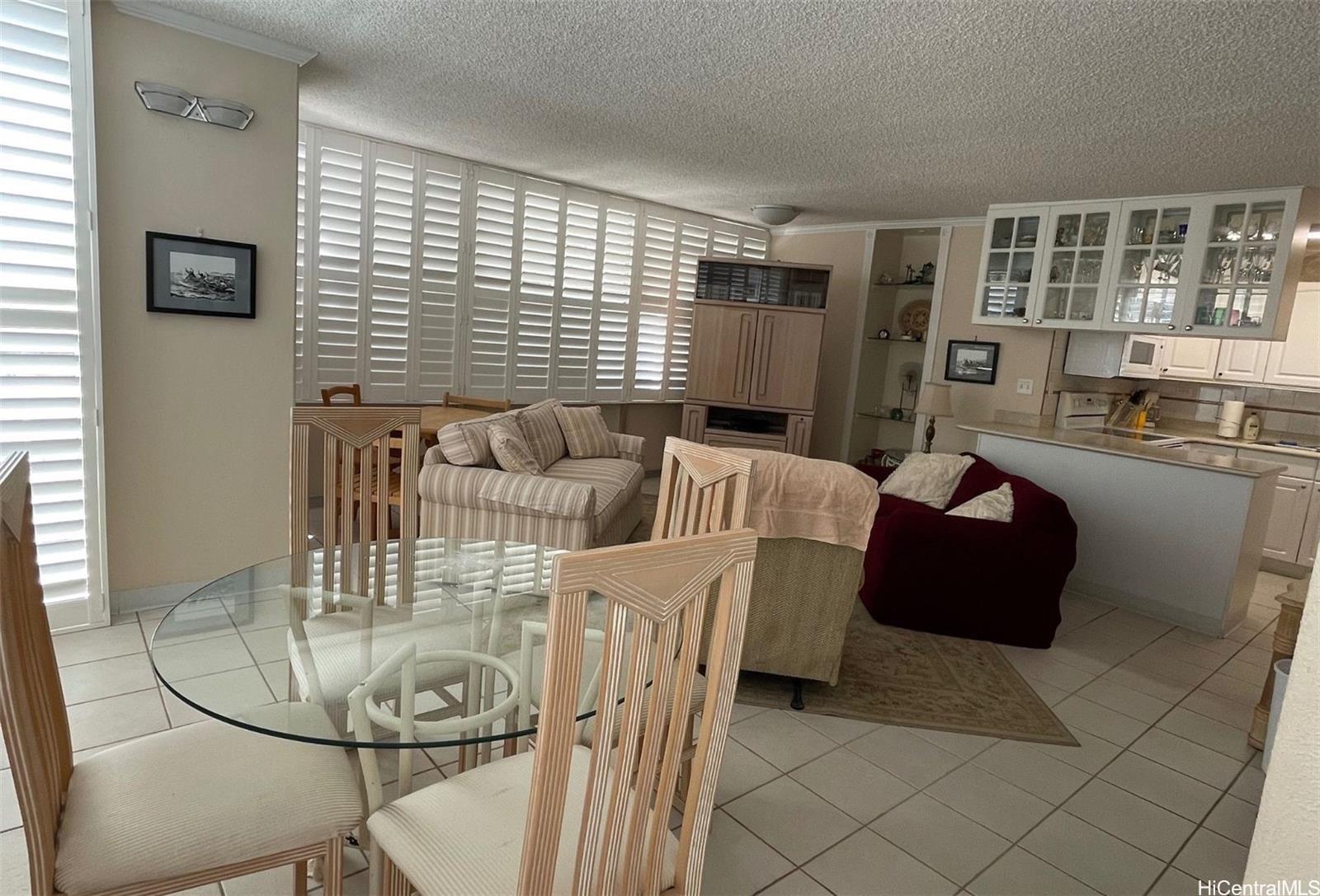 2415 Ala Wai Boulevard, Unit 1208 Honolulu, HI 96815 - Photo 11 of 13 a living room with furniture and a table