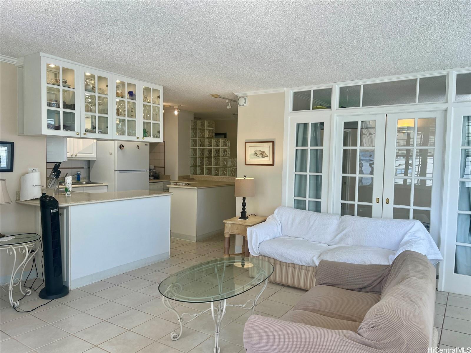 2415 Ala Wai Boulevard, Unit 1208 Honolulu, HI 96815 - Photo 6 of 13 a living room with furniture and large windows