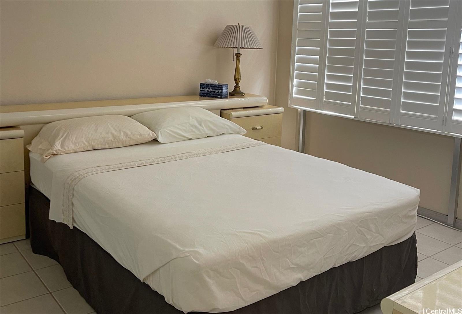 2415 Ala Wai Boulevard, Unit 1208 Honolulu, HI 96815 - Photo 7 of 13 a bed sitting in a bedroom next to a window