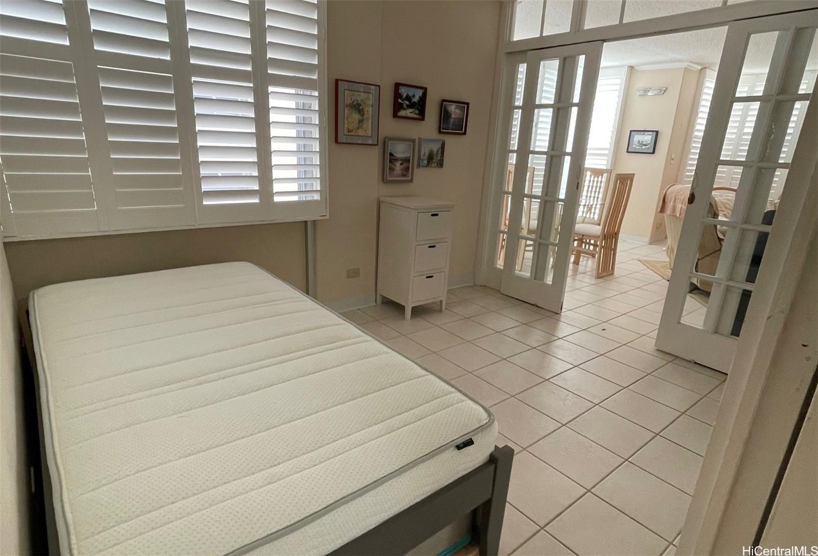 2415 Ala Wai Boulevard, Unit 1208 Honolulu, HI 96815 - Photo 8 of 13 a bed room with a bed and a window