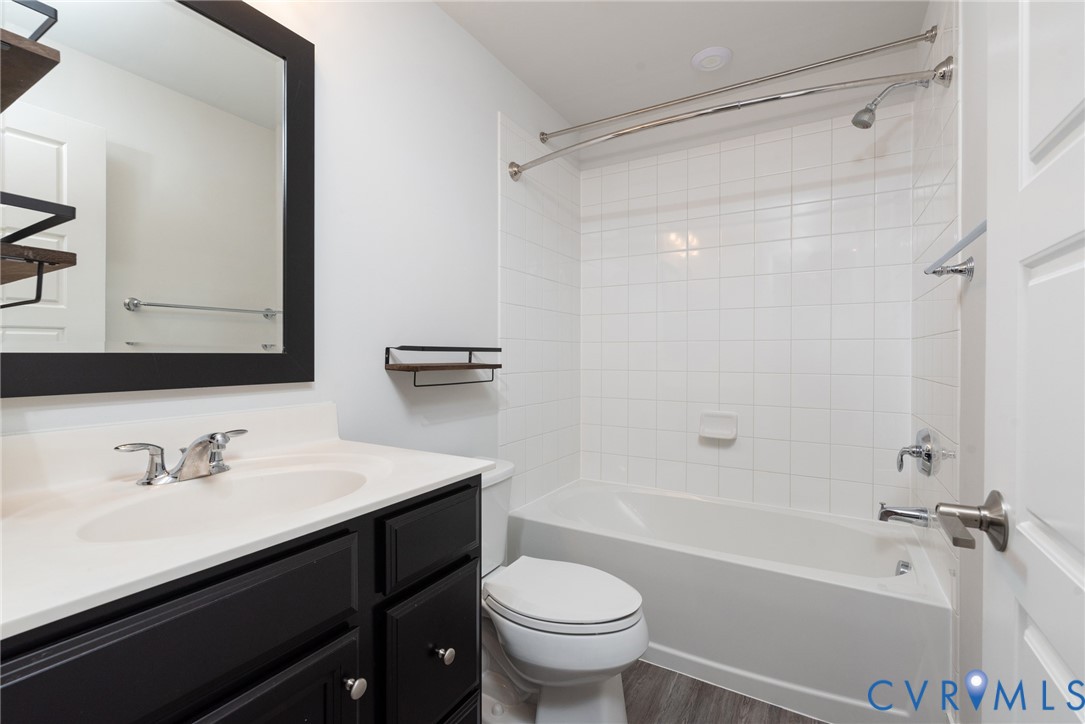 4352 Bon Secours Parkway, Unit A Henrico, VA 23233 - Photo 14 of 16 a bathroom with a sink a toilet a mirror and a shower