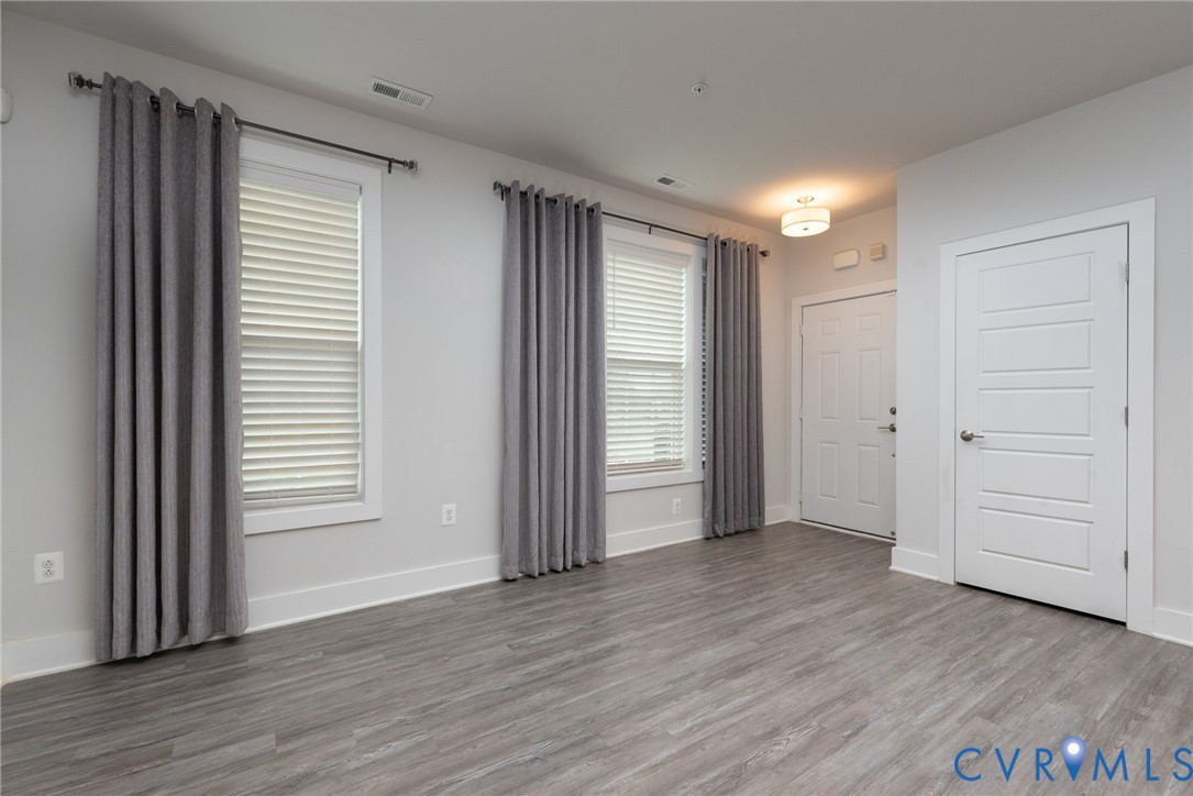 4352 Bon Secours Parkway, Unit A Henrico, VA 23233 - Photo 2 of 16 an empty room with wooden floor and windows