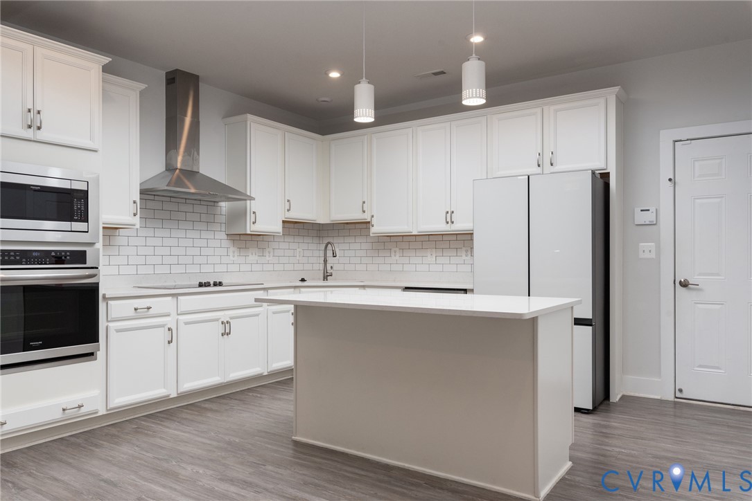 4352 Bon Secours Parkway, Unit A Henrico, VA 23233 - Photo 3 of 16 a kitchen with stainless steel appliances a sink stove refrigerator and cabinets