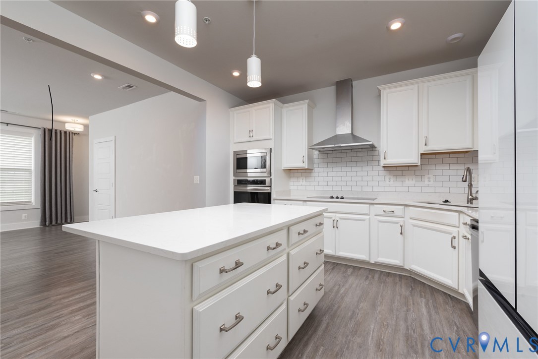 4352 Bon Secours Parkway, Unit A Henrico, VA 23233 - Photo 4 of 16 a kitchen with kitchen island white cabinets and white appliances