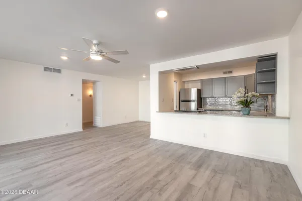 a view of a kitchen with kitchen island and wooden floor
