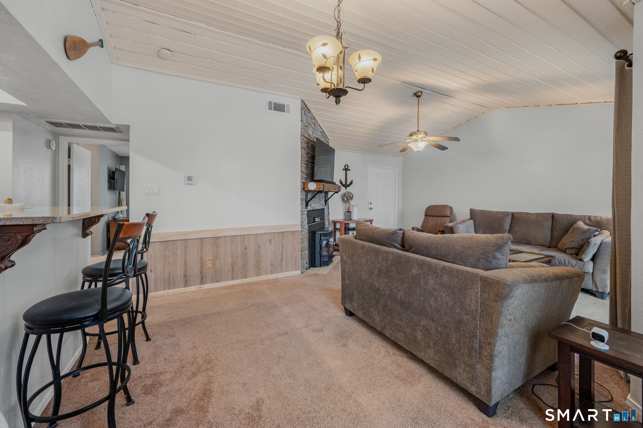 85 Crown Knoll Court, Unit 110 Groton, CT 06340 - Photo 11 of 23 a living room with furniture and a chandelier