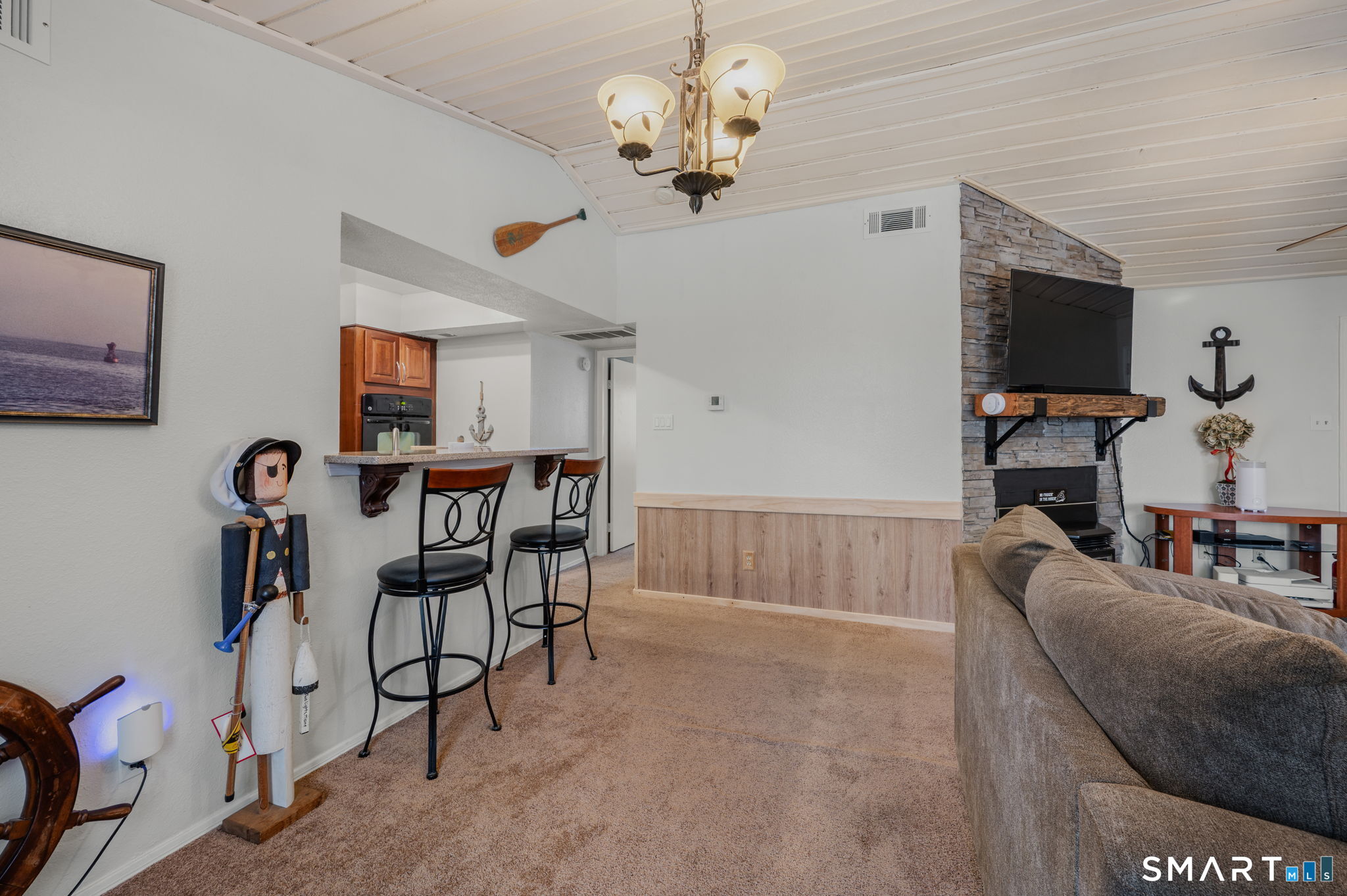 85 Crown Knoll Court, Unit 110 Groton, CT 06340 - Photo 12 of 23 a view of a livingroom with furniture and a flat screen tv