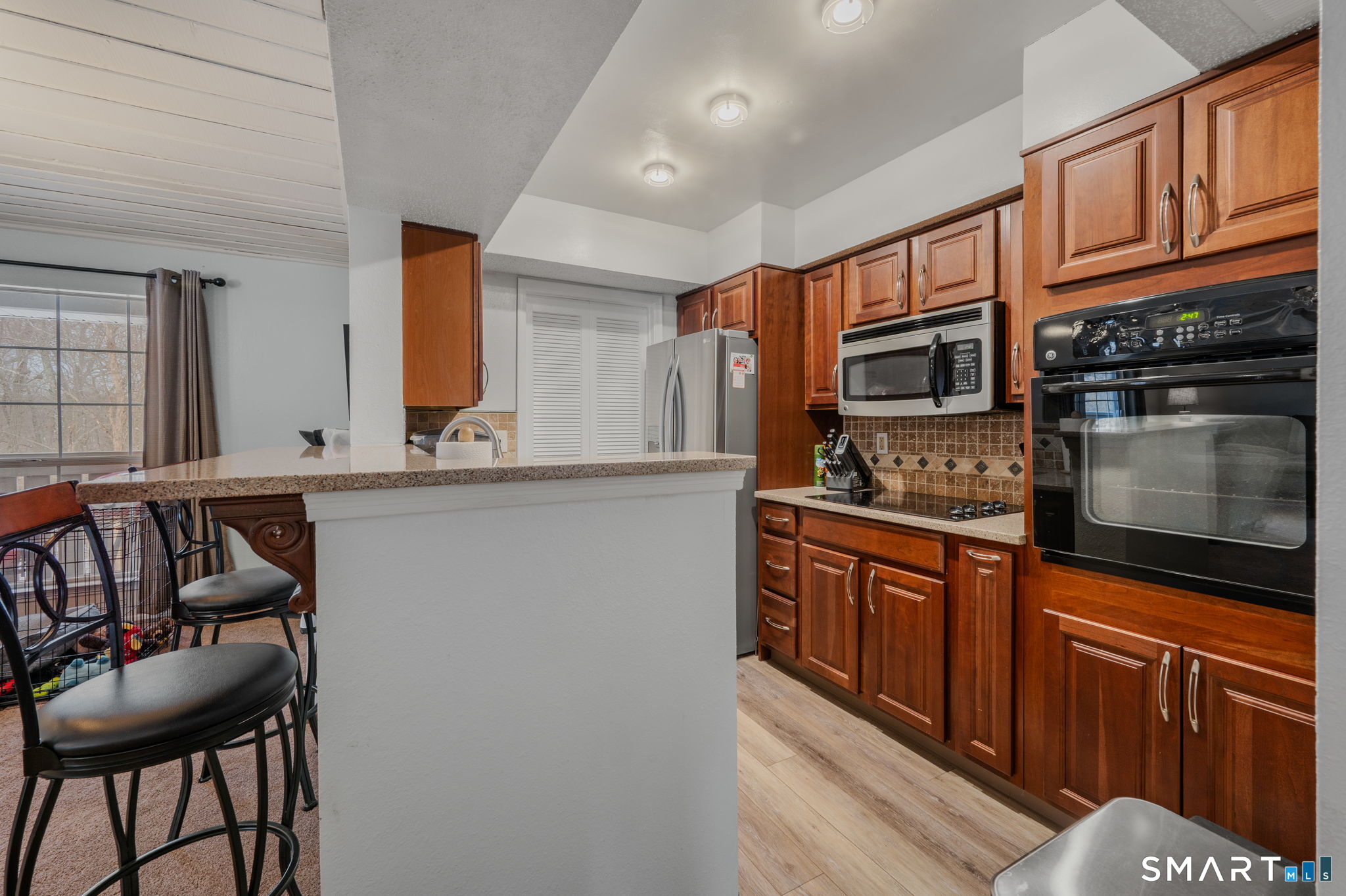 85 Crown Knoll Court, Unit 110 Groton, CT 06340 - Photo 13 of 23 a kitchen with stainless steel appliances granite countertop a stove a sink and a microwave