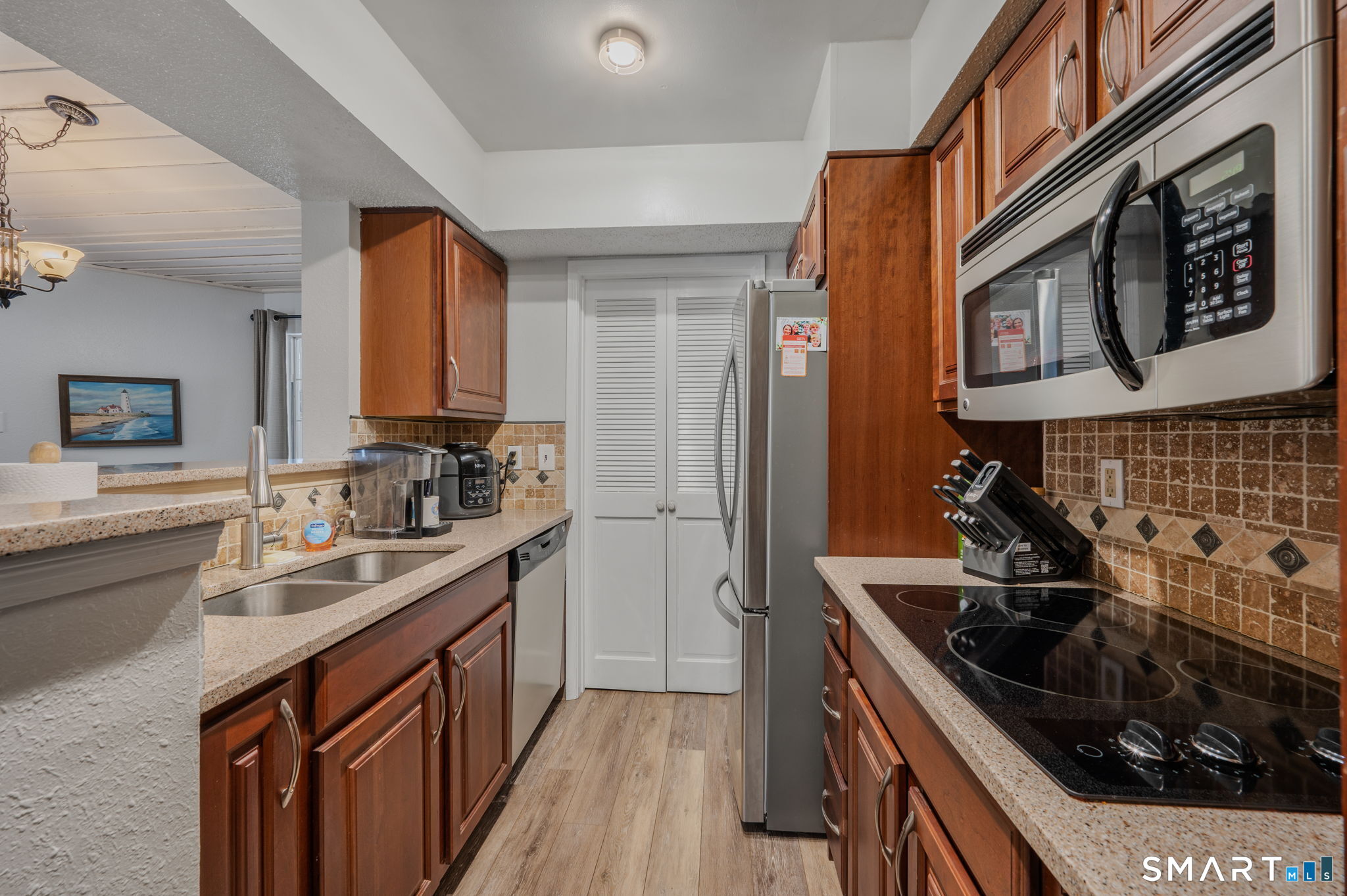 85 Crown Knoll Court, Unit 110 Groton, CT 06340 - Photo 15 of 23 a kitchen with a sink stove top oven and cabinets