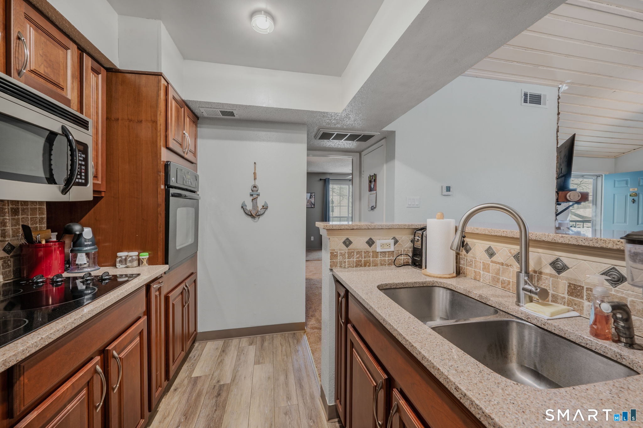 85 Crown Knoll Court, Unit 110 Groton, CT 06340 - Photo 16 of 23 a kitchen with stainless steel appliances granite countertop a sink refrigerator and cabinets