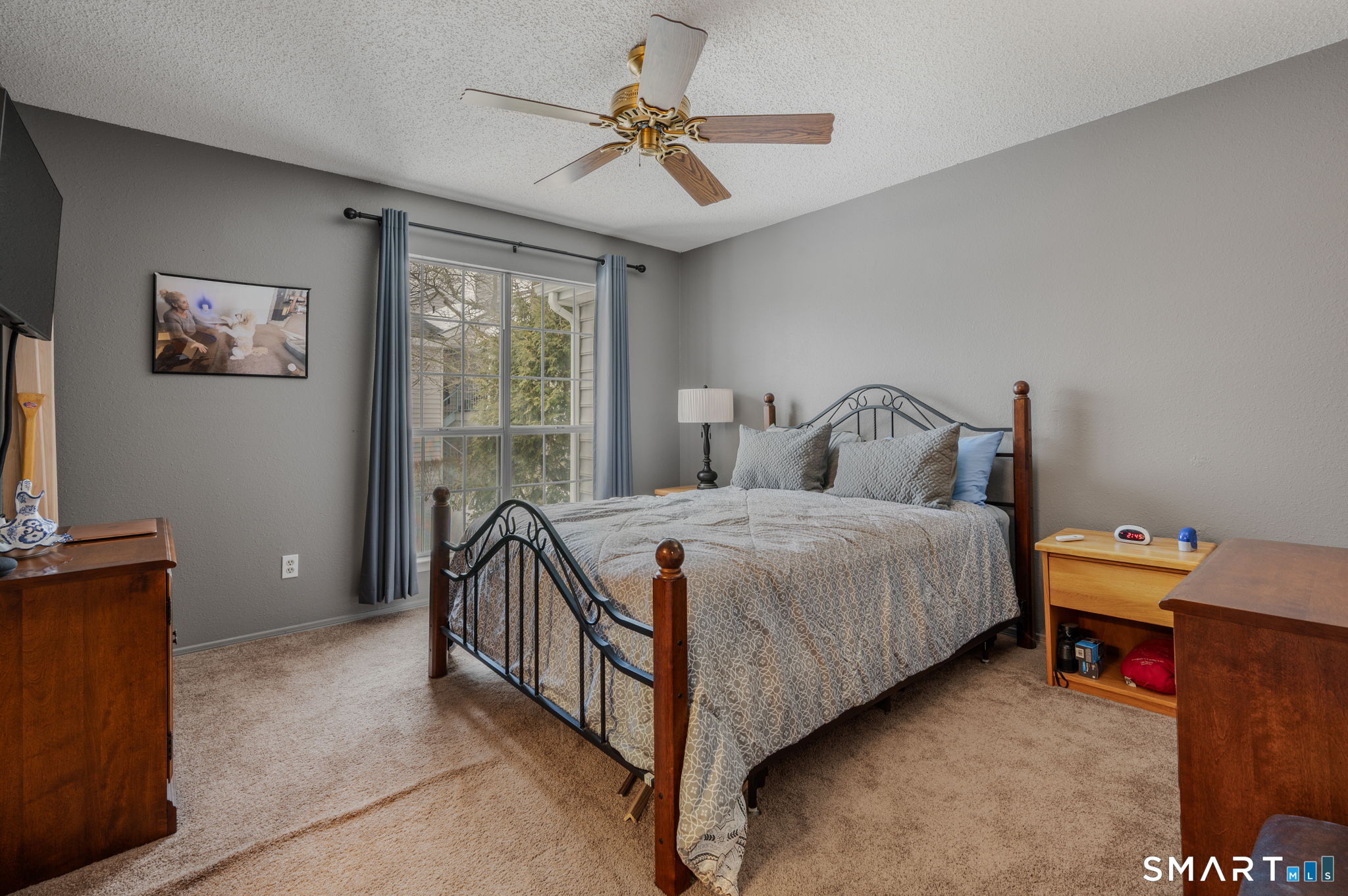 85 Crown Knoll Court, Unit 110 Groton, CT 06340 - Photo 17 of 23 a bedroom with a bed and a chandelier