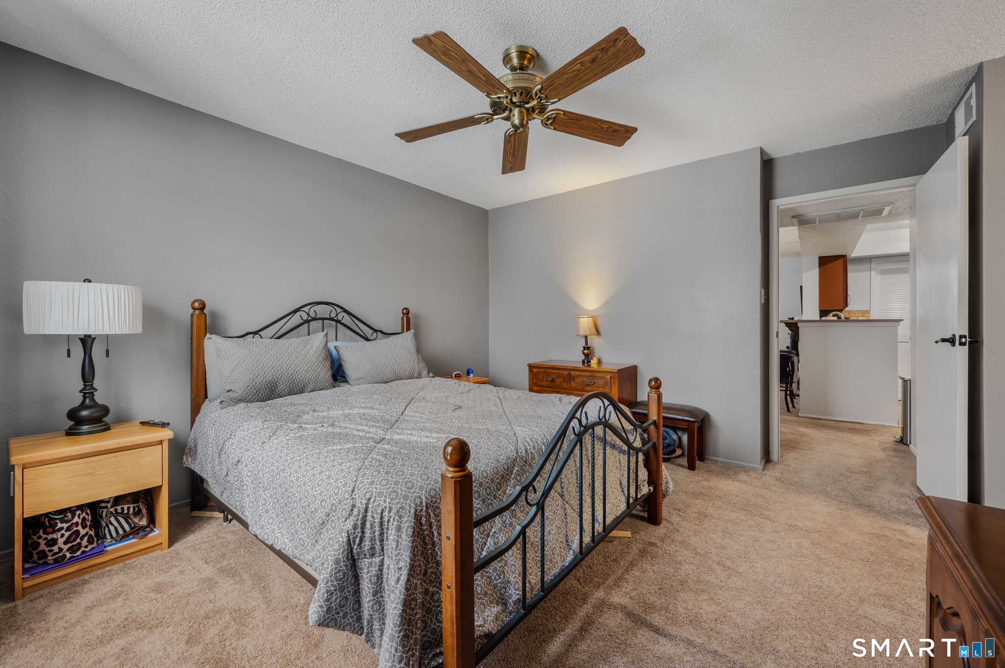 85 Crown Knoll Court, Unit 110 Groton, CT 06340 - Photo 18 of 23 a spacious bedroom with a bed and a chandelier