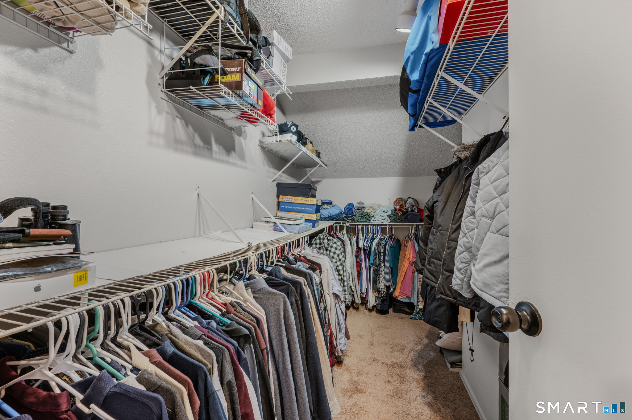 85 Crown Knoll Court, Unit 110 Groton, CT 06340 - Photo 21 of 23 a view of walk in closet with clothes and shoes