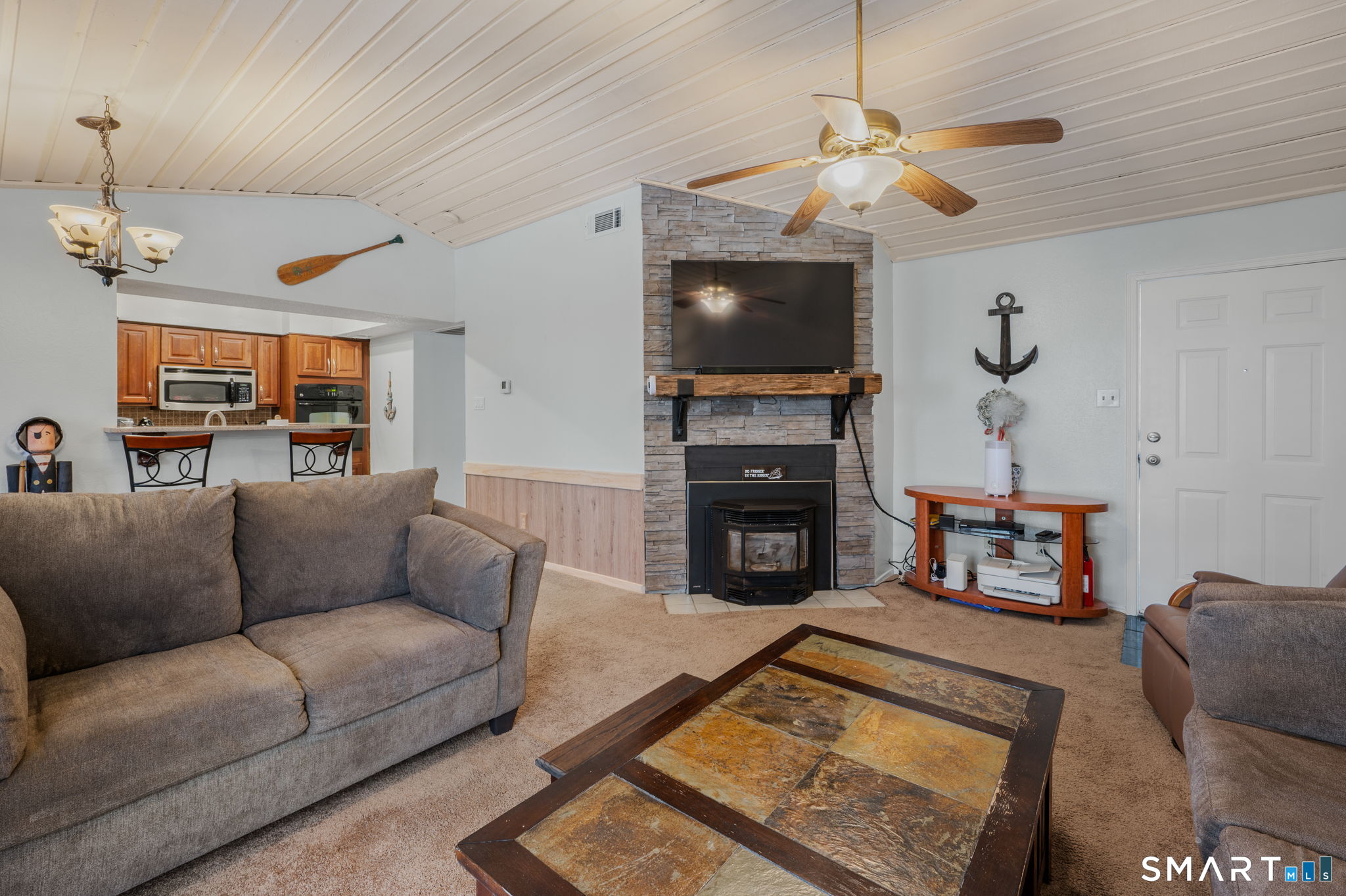 85 Crown Knoll Court, Unit 110 Groton, CT 06340 - Photo 4 of 23 a living room with furniture a fireplace and a flat screen tv