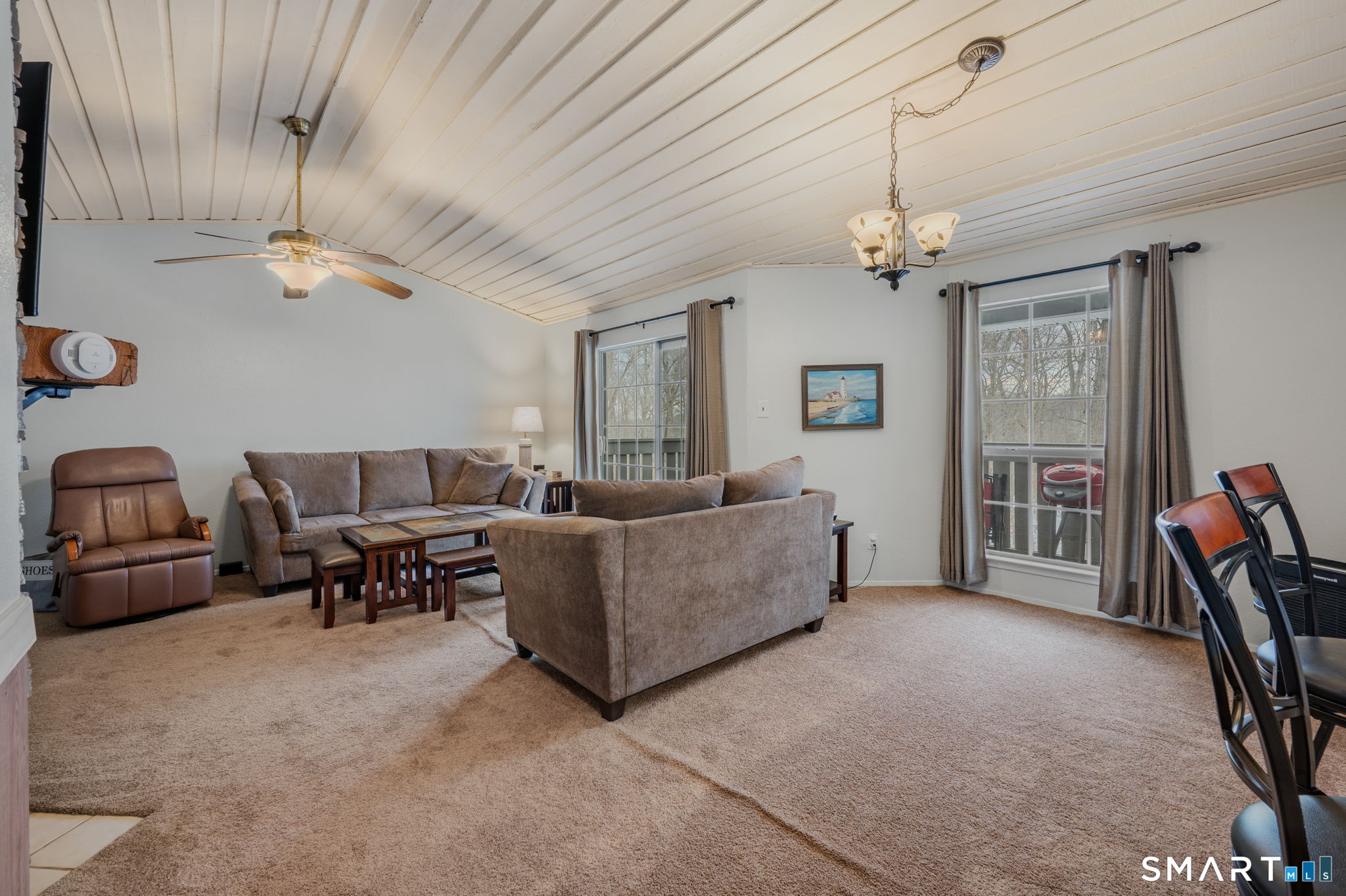 85 Crown Knoll Court, Unit 110 Groton, CT 06340 - Photo 9 of 23 a living room with furniture and a chandelier