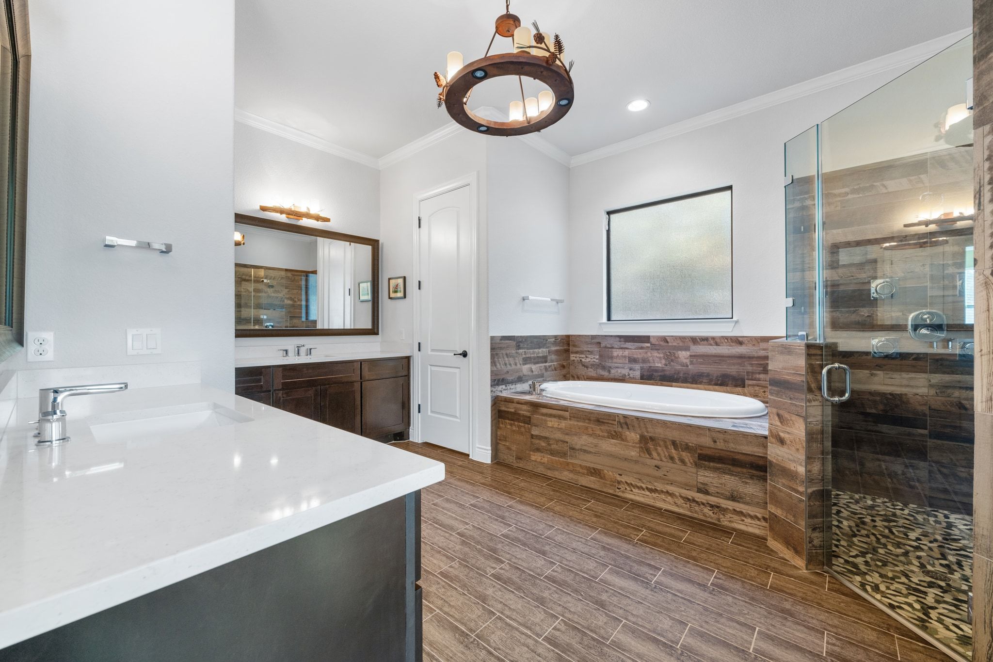 20607 Thurman Bend Road Spicewood, TX 78669 - Photo 16 of 39 a bathroom with a granite countertop sink and a bathtub